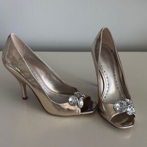 BCBGirls Rose Gold Metallic Peep-Toe Heels with Crystal Embellishment